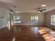 Spacious living room featuring gleaming hardwood floors and two modern ceiling fans at 4720 Fowler Cir, Acworth, GA 30101