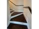 This staircase features hardwood steps with a white base and a dark hardwood handrail at 4720 Fowler Cir, Acworth, GA 30101