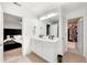 Bathroom featuring a dual sink vanity, large mirror, and entrances to the bedroom and walk-in closet at 4992 Lower Elm St, Atlanta, GA 30349