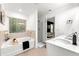 Bright bathroom with a tub, shower, and double vanity, offering a modern and relaxing space at 4992 Lower Elm St, Atlanta, GA 30349