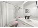 Bathroom showcasing a shower-tub combo, vanity with sink, and a well-lit mirror at 4992 Lower Elm St, Atlanta, GA 30349