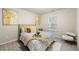Bedroom featuring neutral walls, modern art, and a queen-size bed dressed with plush pillows and a cozy duvet at 4992 Lower Elm St, Atlanta, GA 30349