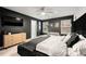 Primary bedroom features dark walls, modern furniture, a ceiling fan, and plenty of natural light at 4992 Lower Elm St, Atlanta, GA 30349