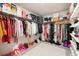 Walk-in closet with shelves, rods, and plenty of storage space for shoes, purses, and clothing at 4992 Lower Elm St, Atlanta, GA 30349