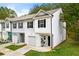 Two-story townhome boasting a one-car garage, neat landscaping, and charming curb appeal in a serene location at 4992 Lower Elm St, Atlanta, GA 30349