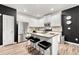 Bright, modern kitchen with stainless appliances, granite counters, a central island, and stylish black accents at 4992 Lower Elm St, Atlanta, GA 30349