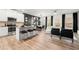 Open-concept kitchen and living area featuring modern finishes, stainless appliances, and a granite-topped island at 4992 Lower Elm St, Atlanta, GA 30349