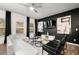 Comfortable living area with a sleek black accent wall, stylish modern furniture, and bright, natural light at 4992 Lower Elm St, Atlanta, GA 30349