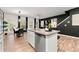 Stylish open-concept living space with modern light fixtures, comfortable seating, and sleek stainless appliances at 4992 Lower Elm St, Atlanta, GA 30349