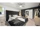 Serene main bedroom features a large upholstered bed, stylish decor, and a ceiling fan at 4992 Lower Elm St, Atlanta, GA 30349