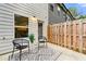 Cozy back patio with two black chairs, a decorative rug, and a wooden fence at 4992 Lower Elm St, Atlanta, GA 30349