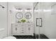 Modern bathroom with double vanity, round mirrors, sleek black hardware, and glass-enclosed shower at , Atlanta, GA 30344