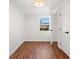 Empty bedroom featuring wood-look floors, white walls, a window with natural light, and modern black door hardware at , Atlanta, GA 30344