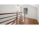 Well-lit hallway with hardwood floors, white walls, dark wood railing, and a window at , Atlanta, GA 30344