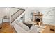 Open-concept living room featuring hardwood floors, stairs, fireplace, and a comfortable sofa at , Atlanta, GA 30344