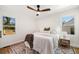 Bright main bedroom with two windows, hardwood floors, modern fan, and a cozy rug at , Atlanta, GA 30344
