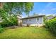 Backyard featuring a lawn, seating area, and view of the home's exterior at 1639 Rogers Sw Ave, Atlanta, GA 30310