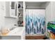 Bathroom area with sink, shelving, and a shower curtain at 1639 Rogers Sw Ave, Atlanta, GA 30310