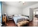 Bedroom featuring hardwood floors, ceiling fan, a bed, and an exit to a kitchen area at 1639 Rogers Sw Ave, Atlanta, GA 30310