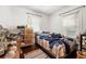 Modest bedroom with wood floors, mini blinds, and a bed at 1639 Rogers Sw Ave, Atlanta, GA 30310