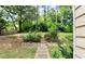 Lush backyard featuring a stone path and steps leading to a serene wooded area at 4335 Burgomeister Pl, Snellville, GA 30039