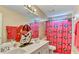 Bathroom with double sink vanity and decorative sports themed shower curtain at 4335 Burgomeister Pl, Snellville, GA 30039