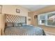 Bedroom with tufted headboard, neutral walls, and natural light at 4335 Burgomeister Pl, Snellville, GA 30039