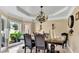 Formal dining room with decorative lighting, large windows, and elegant finishes at 4335 Burgomeister Pl, Snellville, GA 30039