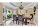Dining room featuring neutral colors, a decorative chandelier, and a large window with natural light at 4335 Burgomeister Pl, Snellville, GA 30039