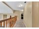 A bright hallway with wooden banister and neutral carpeting creates an inviting transition between spaces at 4335 Burgomeister Pl, Snellville, GA 30039