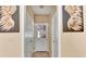 Hallway featuring paneled doors, neutral paint, and tiled floors at 4335 Burgomeister Pl, Snellville, GA 30039