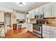 Charming kitchen featuring granite countertops, stainless steel appliances, and hardwood floors at 4335 Burgomeister Pl, Snellville, GA 30039