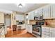 Bright kitchen featuring stainless steel appliances, granite countertops, and custom cabinetry at 4335 Burgomeister Pl, Snellville, GA 30039