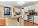 Kitchen with granite countertops, stainless steel appliances, white cabinetry, and hardwood floors at 4335 Burgomeister Pl, Snellville, GA 30039