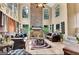 Bright living room with a stone fireplace, tile floors, and large windows that offer great natural light at 4335 Burgomeister Pl, Snellville, GA 30039