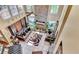 High-angle view of living room featuring stone fireplace, large windows, and comfortable seating at 4335 Burgomeister Pl, Snellville, GA 30039