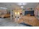 Comfortable bedroom featuring hardwood floors, closet with mirrored doors and plentiful light at 4938 Terrace Green Trce, Stone Mountain, GA 30088