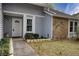 A close up of the house showcasing a white front door, stone accents, and a well-manicured lawn at 4938 Terrace Green Trce, Stone Mountain, GA 30088