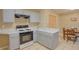 The kitchen features grey cabinets, marble countertops and a view of the dining area at 4938 Terrace Green Trce, Stone Mountain, GA 30088