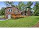 Beautiful backyard featuring a brick house, a well-manicured lawn, and a charming wooden deck at 687 Monticello Se Way, Marietta, GA 30067