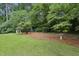 Picturesque backyard with lush green grass, a playhouse, a bird bath, and a shed nestled among the trees at 687 Monticello Se Way, Marietta, GA 30067