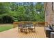 Inviting backyard deck with a table and chairs, surrounded by lush greenery at 687 Monticello Se Way, Marietta, GA 30067