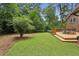 Well-manicured backyard with lush green grass and a wooden deck at 687 Monticello Se Way, Marietta, GA 30067