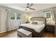 Serene bedroom with hardwood floors, a large bed, and bright windows at 687 Monticello Se Way, Marietta, GA 30067