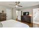 Bright bedroom featuring hardwood floors, a ceiling fan, and ensuite bathroom access at 687 Monticello Se Way, Marietta, GA 30067