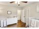 Bright Bedroom room with hardwood floors, crib, changing table and neutral decor at 687 Monticello Se Way, Marietta, GA 30067