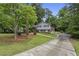 Beautifully landscaped home with a long driveway and mature trees at 687 Monticello Se Way, Marietta, GA 30067