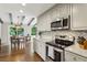 Bright kitchen with gray cabinets, stainless steel appliances, and adjacent dining area at 687 Monticello Se Way, Marietta, GA 30067