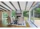 Cozy living area with a brick fireplace, hardwood floors, and natural light from large windows at 687 Monticello Se Way, Marietta, GA 30067