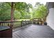 Expansive back deck featuring outdoor seating with views of the lush, private backyard at 13789 Woolsey Rd, Hampton, GA 30228